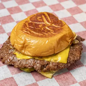 Single patty, 100% fresh beef burger served with American cheese, grilled onions, pickles and house sauce on a Martin's potato bun