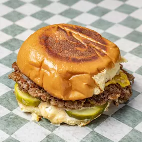 Double Impossible patty served with American cheese, grilled onions, pickles and house sauce on a Martin's potato bun