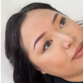 Close-up photo of a client’s ombré powder brows, created by an Asian-owned PMU trainer in Utah, showing a smooth shaded effect.
