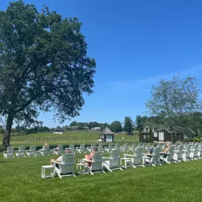 Endless rows of Adirondack chairs offer relaxing views of the vines, trees, and rustic barns at Tranquillity Vineyard & Winery.