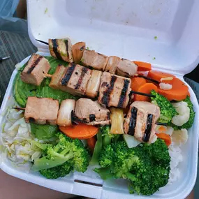 Steamed veggie bowl with tofu skewers