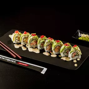 Lobster and cucumber inside topped with layered avocado, sriracha, tobiko, crunchy flakes, sesame seeds and our housemade ginger sauce