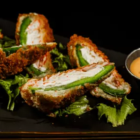 Fresh jalapeños stuffed with krab stick and cream cheese. Served with headbanger sauce swirled with eel sauce.