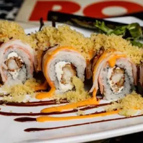 Shrimp tempura and cream cheese inside, krab stick outside, topped with spicy mayo, eel sauce, and crunchy flakes.