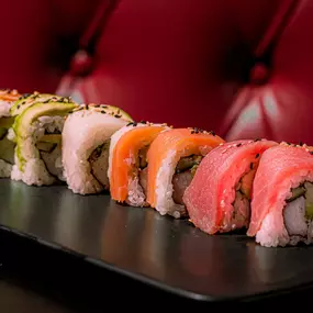 California roll inside, red tuna, fresh salmon, yellowtail and avocado outside, topped with sesame seeds.