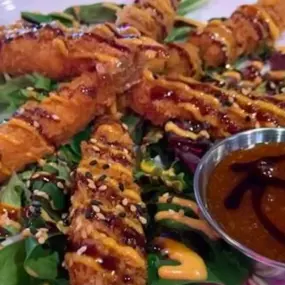 It’s dy-na-mite. Crispy shrimp tempura glazed with sweet chili, savory eel sauce and a sprinkle of sesame seed confetti. Boom.