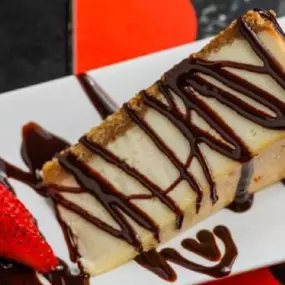 (ORIGINAL OR FRIED) Creamy slice oftraditional cheesecake drizzled with chocolate and caramel, topped withwhipped cream and strawberries. Not-so-traditional? Get it fully fried.