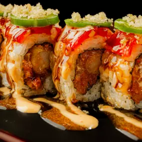 Shrimp tempura and spicy tuna inside, red tuna and jalapeño outside, topped with spicy mayo, sweet chili sauce, eel sauce and crunchy flakes.