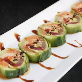 (CUCUMBER WRAP) Red tuna, yellowtail, salmon collaborated with krab stick and avocado wrapped in cucumber peel with sweet chili, ponzu, eel sauce and sesame seeds.  Rice-free.