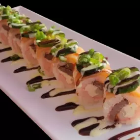 (SOY PAPER WRAP) Seared filet mignon, cream cheese and krab stick inside. Smoked salmon and jalapeño slices on top with green onion, creamy wasabi and eel sauce.