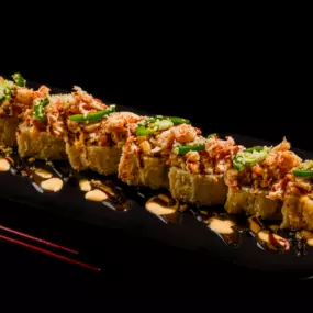 Fried or Baked. Shrimp tempura, krab stick, cream cheese inside, fully fried OR baked, with Cajun seasoned crawfish, baked krab meat, jalapeño, spicy mayo, sweet chili, eel sauce and crunchy flakes.