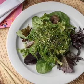 Sweet and savory wakame on spring mix.