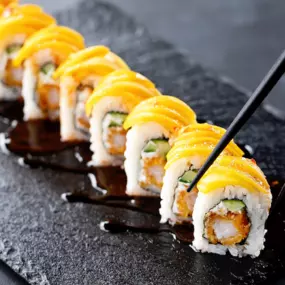 Shrimp tempura, cream cheese and cucumber inside, sliced mango outside, topped with sweet chili and eel sauce.