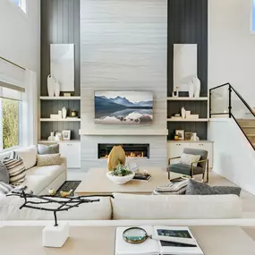 Expansive windows in the two-story great room of the Cirrus draw light throughout the home