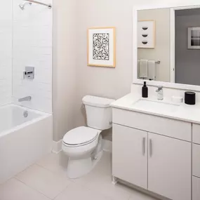 Large Soaking Tub In Bathroom with white cabinets