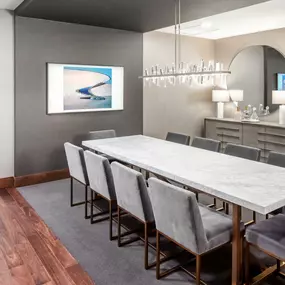 Modern dining room with a long table and grey chairs