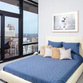 Spacious Bedrooms with a large bed and a view of the city