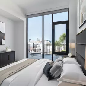 The bedroom at The Holston offers a peaceful space that opens up to a private balcony.