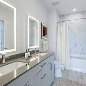 The bathroom at The Holston offers a clean, modern space complete with a relaxing bathtub.