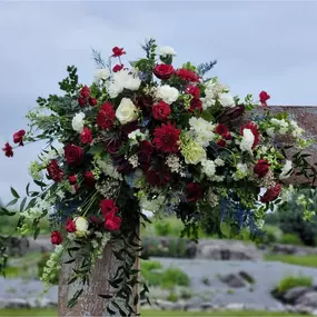 Red flower archway design custom made by Christina, a wedding florist in Hagerstown Maryland.