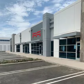 Exterior view of Methods Machine Tools' new Southern California facility in Corona, showcasing the company’s modern building signage and entrance.