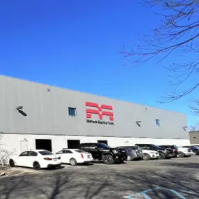 Exterior view of Methods Machine Tools Inc. facility in Wixom, Michigan, showcasing the building’s modern design and signage.