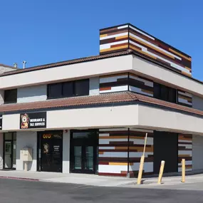 The 4P Taxes office is located at 418 N 175 E, Suite 210, in a two-story stucco and wood-accented building next to Smith’s on 400 North in Logan, Utah. The ground level features large windows that let in natural light, and the clear 4P Taxes signage, featuring their logo, sits prominently above the entrance. The overall design is clean and modern, projecting a professional and approachable atmosphere for clients visiting for payroll, tax, bookkeeping, and accounting services.