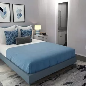 A blue and white bedroom with a bed and a closet