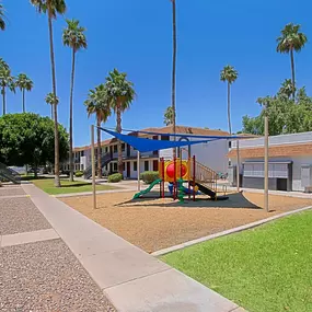 A playground with a slide and a swing set.