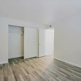 A room with a white door and a white wall.