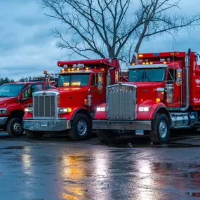 Fleet of Forbes Asphalt trucks lined up at dusk, ready for dispatch.