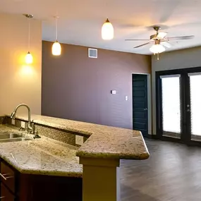 A kitchen with a marble countertop and a sink