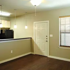 A kitchen area with a counter and cabinets