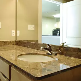 A bathroom with a sink and mirror.