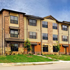 A large brick apartment building with multiple windows and balconies.