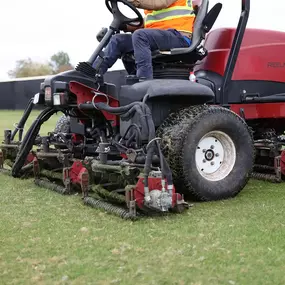 person driving a lawnmower