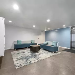 Lobby with blue couches and a table