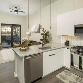 A modern kitchen with a stainless steel dishwasher and oven.