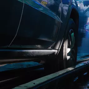 A vehicle glides through the illuminated tunnel wash at Red Carpet Car Wash Canoga Park, highlighting the location’s advanced automated cleaning system and smooth ride-through experience.