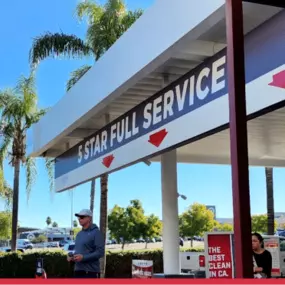 A sunny exterior shot of Red Carpet Car Wash Canoga Park showcases the facility’s curb appeal and signature branding. Positioned conveniently near Topanga Canyon Blvd, this image highlights the location’s accessibility and welcoming environment for drive-in service.