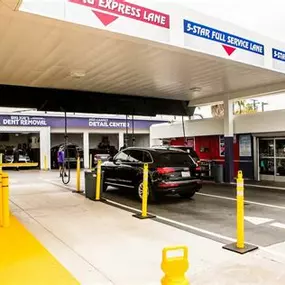 Vehicles queue beneath the ‘Unlimited Washing’ canopy at Red Carpet Car Wash Canoga Park. This image captures the location’s high-volume, full-service flow and promotes its popular Unlimited Wash Club. Clean, professional, and efficient service in the heart of Canoga Park.