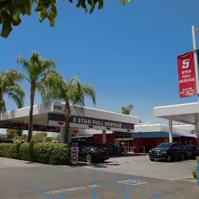 A wide-angle exterior view of Red Carpet Car Wash Canoga Park, featuring its prominent 5 Star Full Service signage, palm-lined driveway, and clear entry signage. This image conveys the welcoming and professionally maintained appearance of the location, highlighting its position as a trusted full-service car wash destination in the San Fernando Valley.