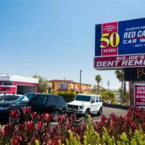 Prominent entrance signage at Red Carpet Car Wash Manhattan Beach featuring “Big Joe’s Dent Removal” and the “Always Depend On Red Carpet since 1972” tagline. Highlights the location’s legacy, exclusive dent repair service, and commitment to quality.