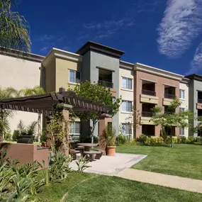 Apartment complex with a green lawn in front.