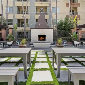 A patio with a fireplace and seating area.
