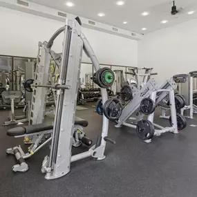 A gym with a variety of equipment including a leg press machine.