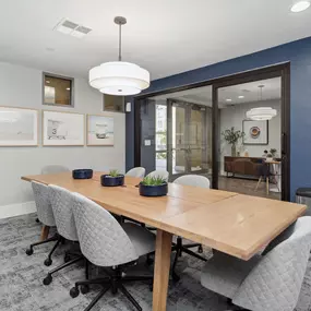 A conference room with a long table and chairs.