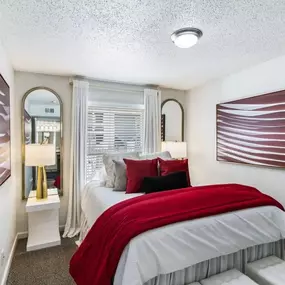 A bedroom with a bed and a window