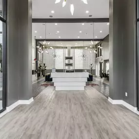 A lobby with a reception area and large windows