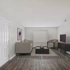 A living room with a grey couch and a tv